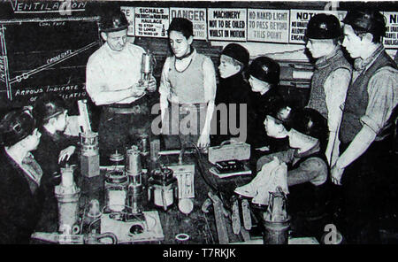 A vintage press photo showing school leavers training as coal miners and undergoing safety training in Britain - Circa 1940's Stock Photo
