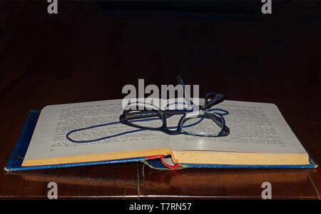 Open book close-up with eye-glasses Stock Photo