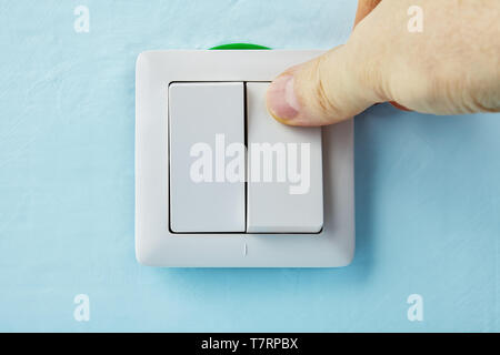 Repairman is pressing the button of new european standard  push button, electric installation work. Stock Photo