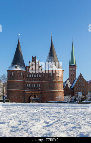 The Brick Gothic city gate Holstentor/ Holstein Gate in the Hanseatic town Lübeck in winter, Schleswig-Holstein, Germany Stock Photo