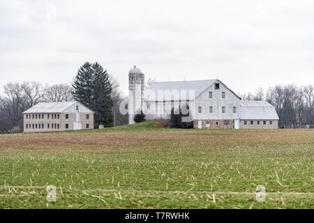 Mechanicsburg, USA - April 6, 2018: Rural Pennsylvania farm countryside mountain scenery in spring with house and silo farmhouse building Stock Photo