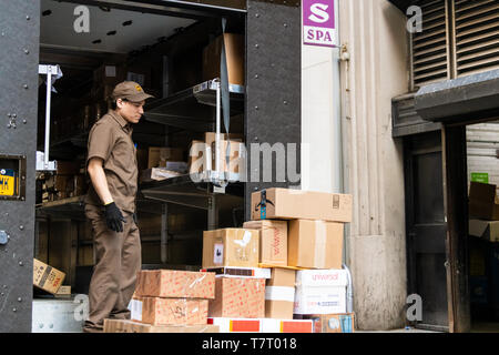 New York City, USA - April 6, 2018: Manhattan NYC UPS, United Parcel Service, man unloading packages delivery in midtown Stock Photo