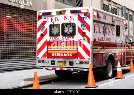 New York City - April 6, 2018: NYC midtown with FDNY red ambulance truck parked on street Stock Photo