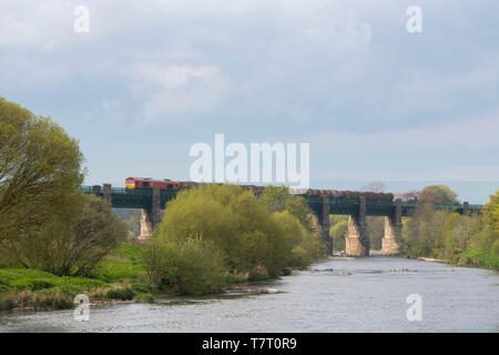 A Goods train, Hauled by a DB Schenker Class 66 Diesel Locomotive, Crosses the River North Esk on the Marykirk Viaduct. Stock Photo