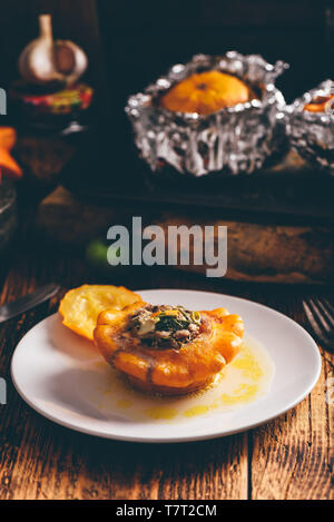 Yellow pattypan squash stuffed with minced meat on white plate Stock Photo
