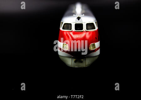 Naples, Italy 22 April 2019. A model of a fast train locomotive pointing towards the camera, on a black background. Stock Photo