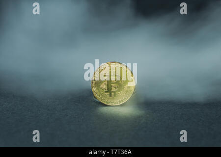 Golden bitcoins with smoke on black background. Business concept. Internet security and protection concept. Stock Photo