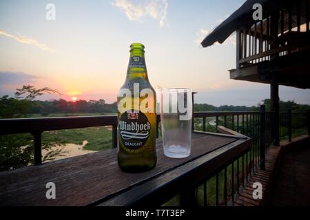 A bottle of cold Windhoek Draught beer, overlooking Crocodile river, Kruger Park. Stock Photo