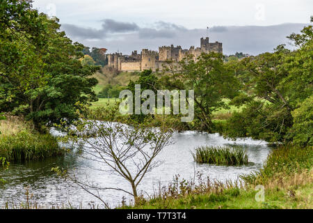 Alnwick Castle from across the River Aln in late summer. Alnwick, Northumberland, UK. October 2018. Stock Photo