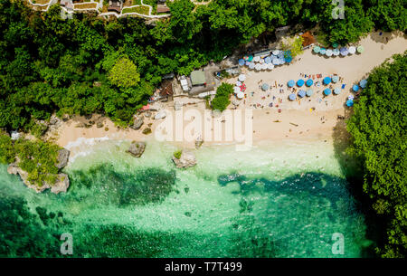 Tourists relax at the Padang Padang Beach featured in the movie 'Eat Pray Love' in Bali, Badung. Stock Photo