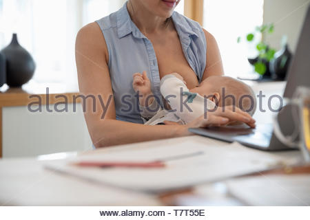 Nude mother breastfeeding her baby Stock Photo - Alamy