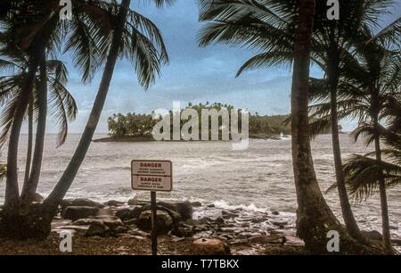 French Guiana. 10th Apr, 2000. A view of the rocky islet of Devils Island (ÃŽle du Diable) from Ile Royale, one of the three islands (Royale, Saint-Joseph, and Diable) of the volcanic ÃŽles du Salut group off French Guiana, collectively called Devils Island (ÃŽle du Diable). Now a nature reserve, serving tourists and cruise ship passengers, visitors are not allowed on small Devils Island but tour the decaying old prison facilities on nearby Isle Royale. Credit: Arnold Drapkin/ZUMA Wire/Alamy Live News Stock Photo