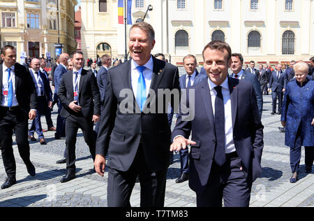 Sibiu, Romania. 9th May, 2019. Romanian President Klaus Werner Iohannis (L, front) walks with French President Emmanuel Macron in Sibiu, Romania, on May 9, 2019. The leaders of the European Union (EU) member states on Thursday agreed on defending 'one Europe' and upholding the rules-based international order in their '10 commitments' declaration, made at an informal summit in Sibiu, central Romania. Credit: Chen Jin/Xinhua/Alamy Live News Stock Photo