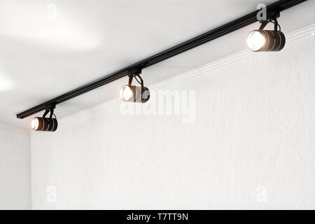 Spotlights under the ceiling on the wall. Track LED-lighting system Stock Photo
