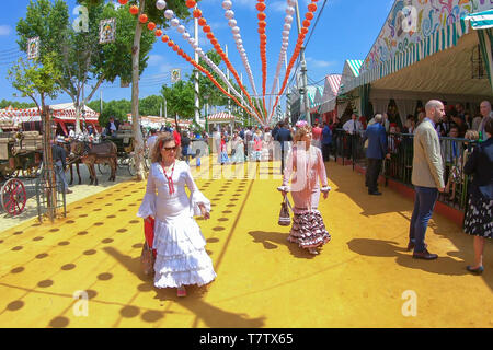 Seville, Spain - May 5, 2019: People walking by  the April Fair of Seville on May, 5, 2019 in Seville, Spain Stock Photo