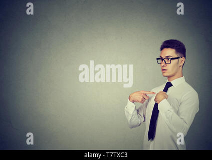 Confused business man pointing fingers at himself Stock Photo