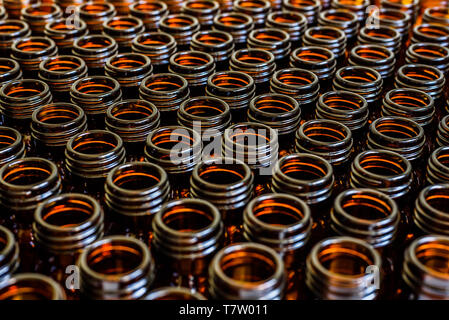 Many glass jars for empty medicines assorted in a row, chemical pharmaceutical industry concept. Stock Photo
