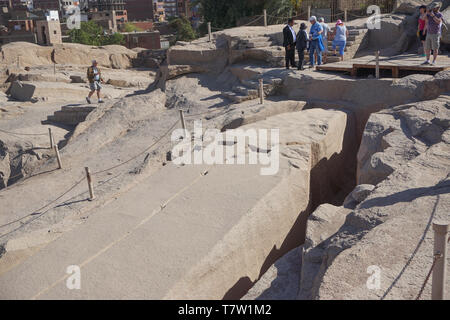 Aswan, Egypt: Tourists visit the unfinished obelisk, originally ordered by Hatshepsut (1508–1458 BC), in a stone quarry in Aswan, Egypt. Stock Photo