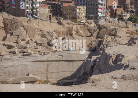 Aswan, Egypt: Tourists visit the unfinished obelisk, originally ordered by Hatshepsut (1508–1458 BC), in a stone quarry in Aswan, Egypt. Stock Photo