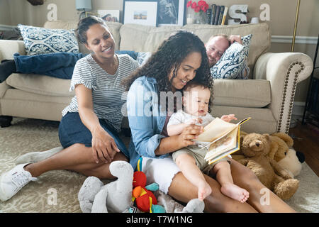family of  4 in their home north Philadelphia, 6 month old baby, 15 year old sister. Stock Photo