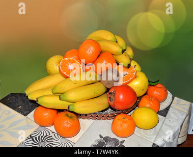 Various exotic fruits set in a basket on a table Stock Photo