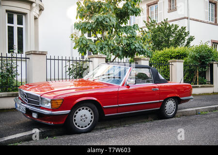 Strasbourg, France - May 19, 2017: Front view of luxury vintage red convertible cabriolet Mercedes-Benz 300 Sl parked in front of French luxury house in calm neighborhood Stock Photo