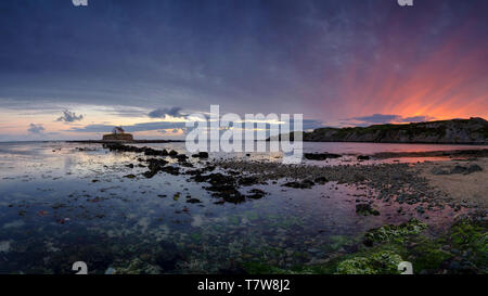 Porth Cwyfan, UK - May 3, 2019: 'The Church in the Sea' (eglwys bach y mor) at Port Cwyfan. Stock Photo