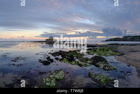 Porth Cwyfan, UK - May 3, 2019: 'The Church in the Sea' (eglwys bach y mor) at Port Cwyfan. Stock Photo