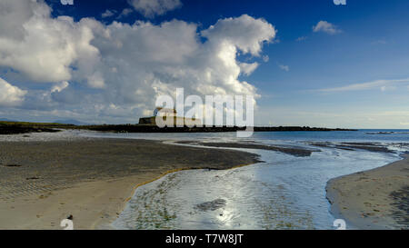 Porth Cwyfan, UK - May 3, 2019: 'The Church in the Sea' (eglwys bach y mor) at Port Cwyfan. Stock Photo