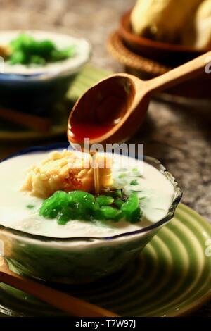 Es Cendol Durian or Es Dawet Duren. Peranakan cold dessert of pandan noodle jelly with durian in coconut milk soup. Stock Photo