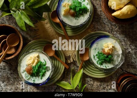 Es Cendol Durian or Es Dawet Duren. Peranakan cold dessert of pandan noodle jelly with durian in coconut milk soup. Stock Photo