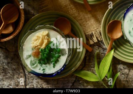 Es Cendol Durian or Es Dawet Duren. Peranakan cold dessert of pandan noodle jelly with durian in coconut milk soup. Stock Photo