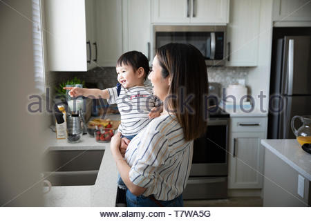 Mother and cute toddler daughter in kitchen Mother and cute toddler daughter in kitchen