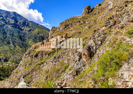 Pinkuylluna archeological site of ancient Inca houses to store crops. Houses located on mountain side, above city of Ollantaytambo in a Sacred Valley  Stock Photo