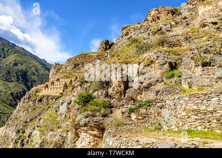 Pinkuylluna archeological site of ancient Inca houses to store crops. Houses located on mountain side, above city of Ollantaytambo in a Sacred Valley  Stock Photo