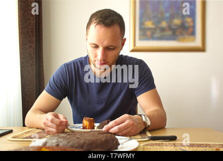 Portrait of the young man having lunch Stock Photo