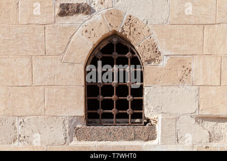 Old fortress stone wall with small window. Background photo texture Stock Photo