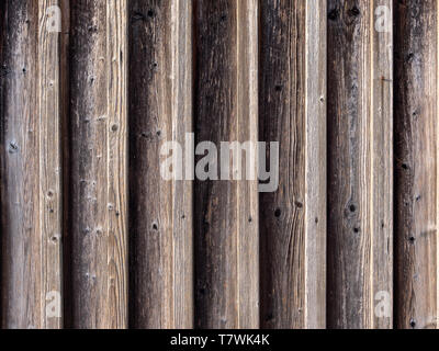Image of symmetric wooden wall with vertical orientation in sun light Stock Photo