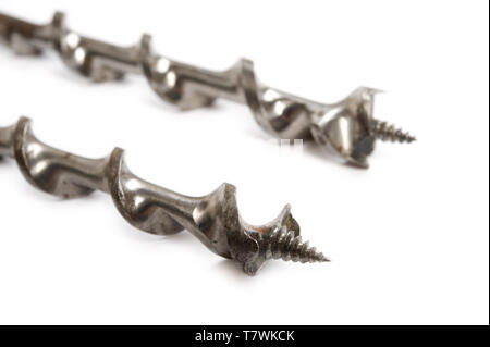 Drill bits for woodwork on white background. Focus on foreground, shallow depth of field. Stock Photo