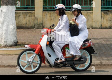 Vietnam, An Giang Province, Mekong Delta Region, Chau Doc, two young students in traditional Vietnamese dress, the Ao Dai Stock Photo