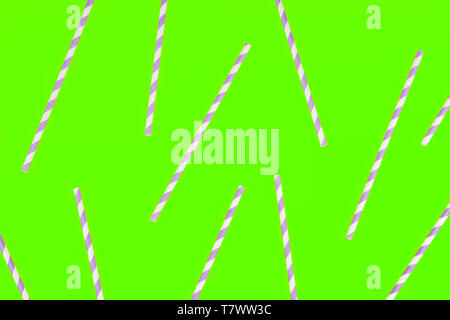 Purple paper straws on neon green color background. Pattern Stock Photo