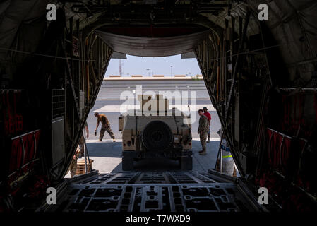 U.S. Soldiers assigned to the East Africa Response Force (EARF), Combined Joint Task Force-Horn of Africa, back a HMMWV onto a C-130J Hercules assigned to the 75th Expeditionary Airlift Squadron during an emergency deployment response exercise at Camp Lemonnier, Djibouti, May 1, 2019. The EARF provides a broad range of rapidly deployable military capabilities to protect American interests on the African continent should any threat arise. (U.S. Air Force photo by Tech. Sgt. Thomas Grimes)