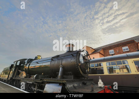 Low-angle close up of vintage UK steam locomotive, Bradley Manor 7802, arriving at Kidderminster station on a summer evening. Stock Photo