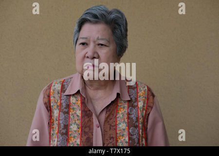 bored depressed asian elder woman. elderly female feeling sad lonely. senior lifestyle Stock Photo