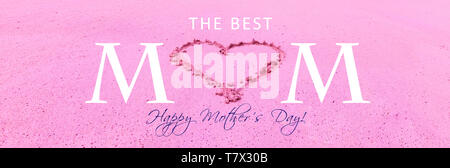 Pink Happy Mothers Day greeting card with text and heart drawing in beach sand texture background. Stock Photo