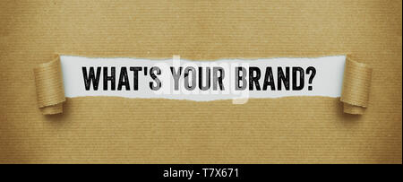 Torn brown paper revealing the words What is your brand Stock Photo