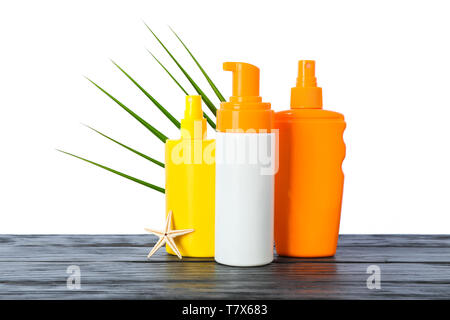 Sunscreen sprays with starfish and palm leaf on wooden table isolated on white background. Safe tan accessories Stock Photo