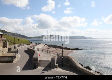 Lyme Regis Harbour, Dorset - Coastal view from East of Cobb Gate towards Charmouth, 2019 with copy space Stock Photo