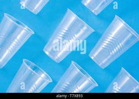Disposable waste plastic cups pattern  on blue background Stock Photo