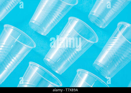 Disposable waste plastic cups pattern  on blue background Stock Photo